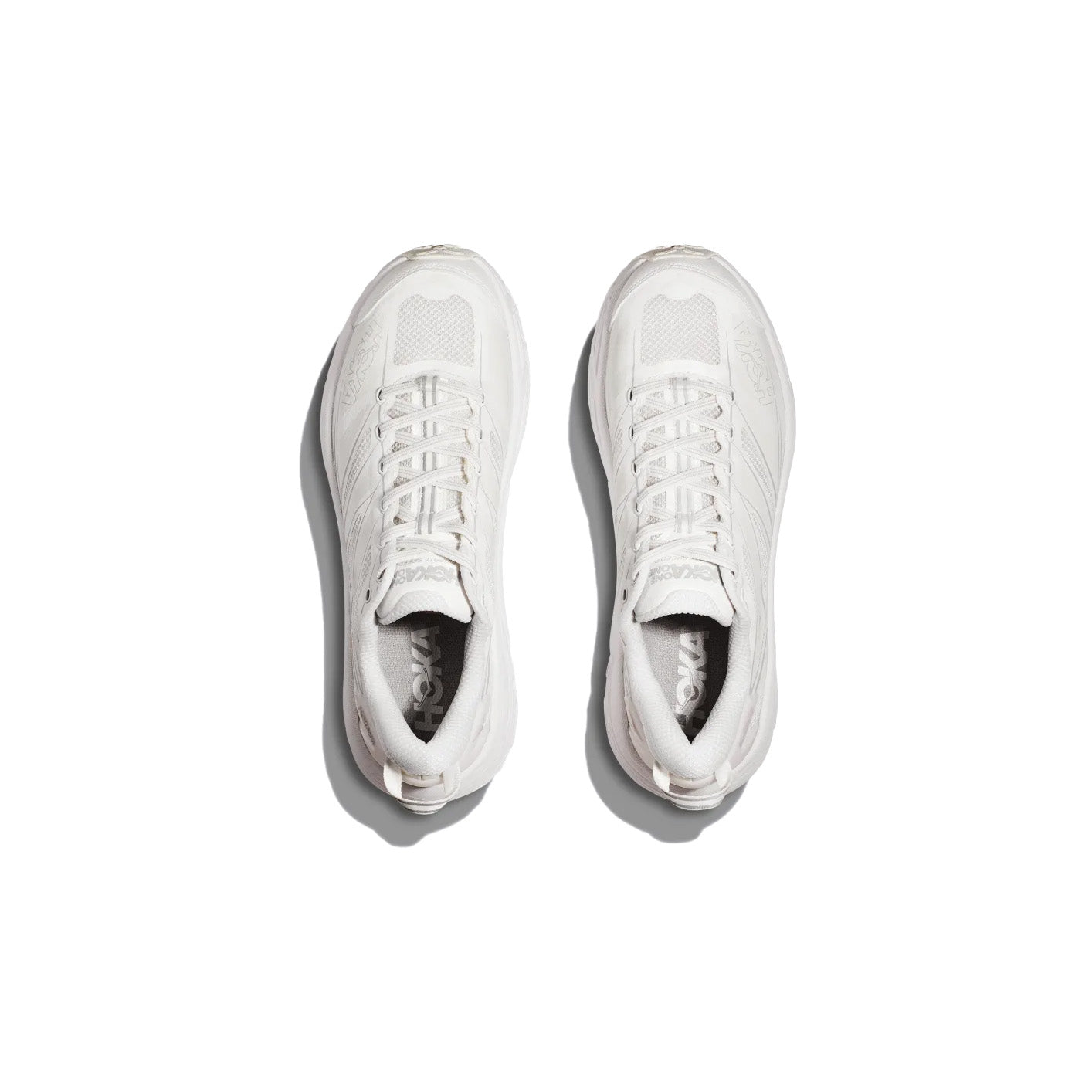 Top view of Hoka U Mafate Speed 2 in White/Lunar Rock with Vibram Mega-Grip soles, side by side on a plain white background—ideal for trail adventures.