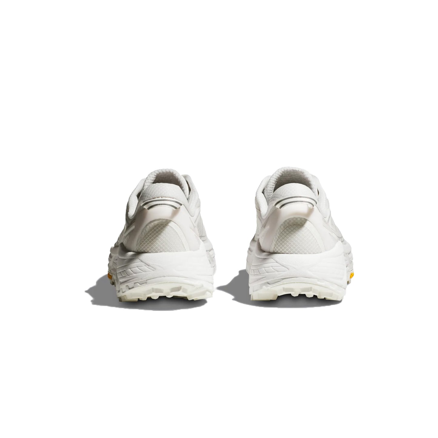 The Hoka U Mafate Speed 2 in White/Lunar Rock, shown from the back to highlight the heel and Vibram Mega-Grip sole, is perfect for trail adventures against a clean white backdrop.