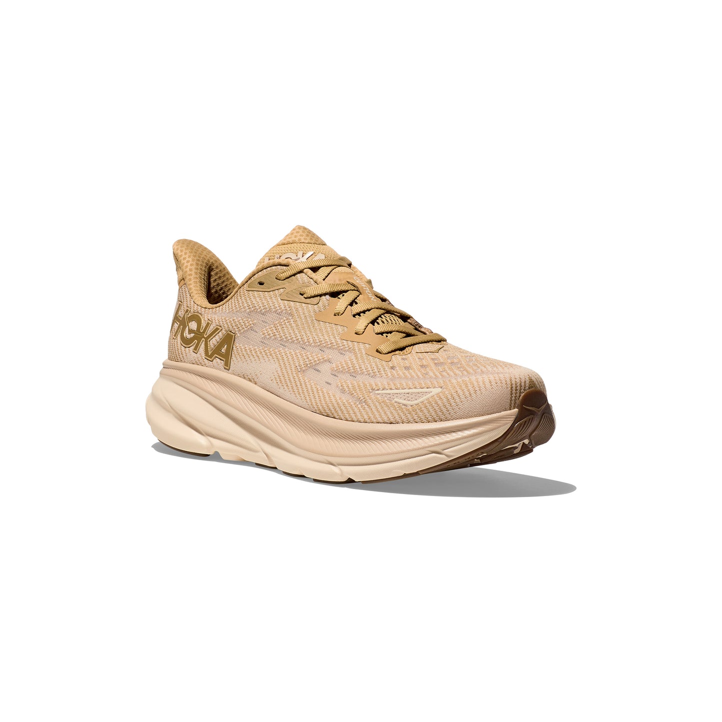 The Hoka M Clifton 9 in Wheat/Shifting Sand features a thick, cushioned sole for comfort and responsive toe-off, plus "HOKA" branding on the side—a stylish, high-performance running shoe from the renowned Clifton 9 series. Displayed on white.