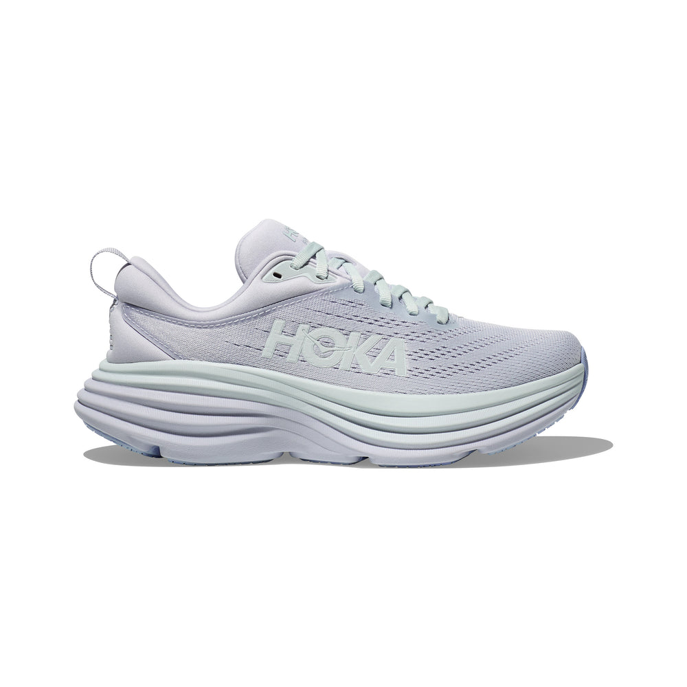 The W Bondi 8 sneaker by Hoka, in Ether/Illusion, features a thick cushioned sole for a balanced ride and a breathable mesh upper showcasing the signature "HOKA" branding.