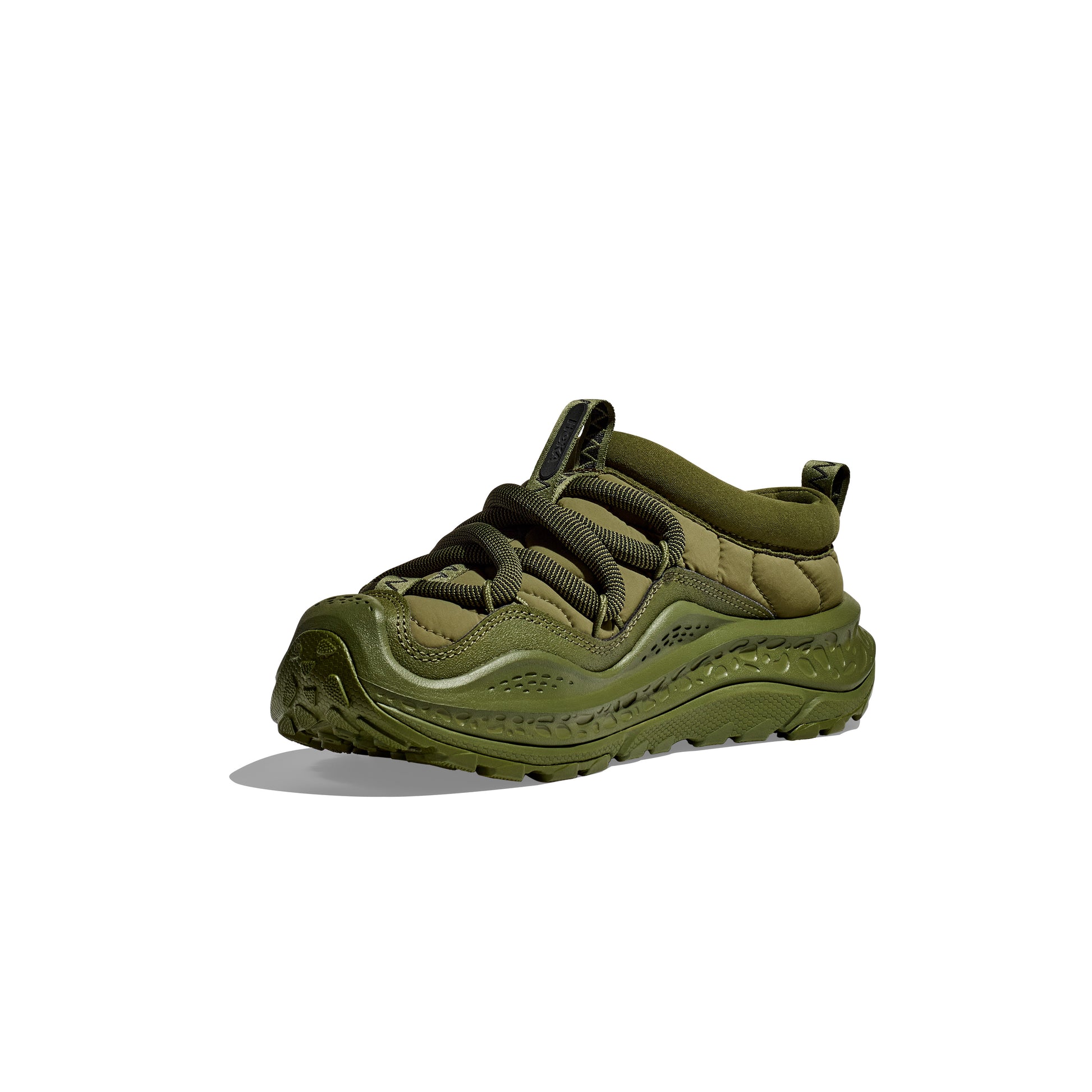 The U Ora Primo sneaker by Hoka in olive green features a chunky, textured sole and thick black laces, set against a white background, combining style with recovery-ready comfort in every step.