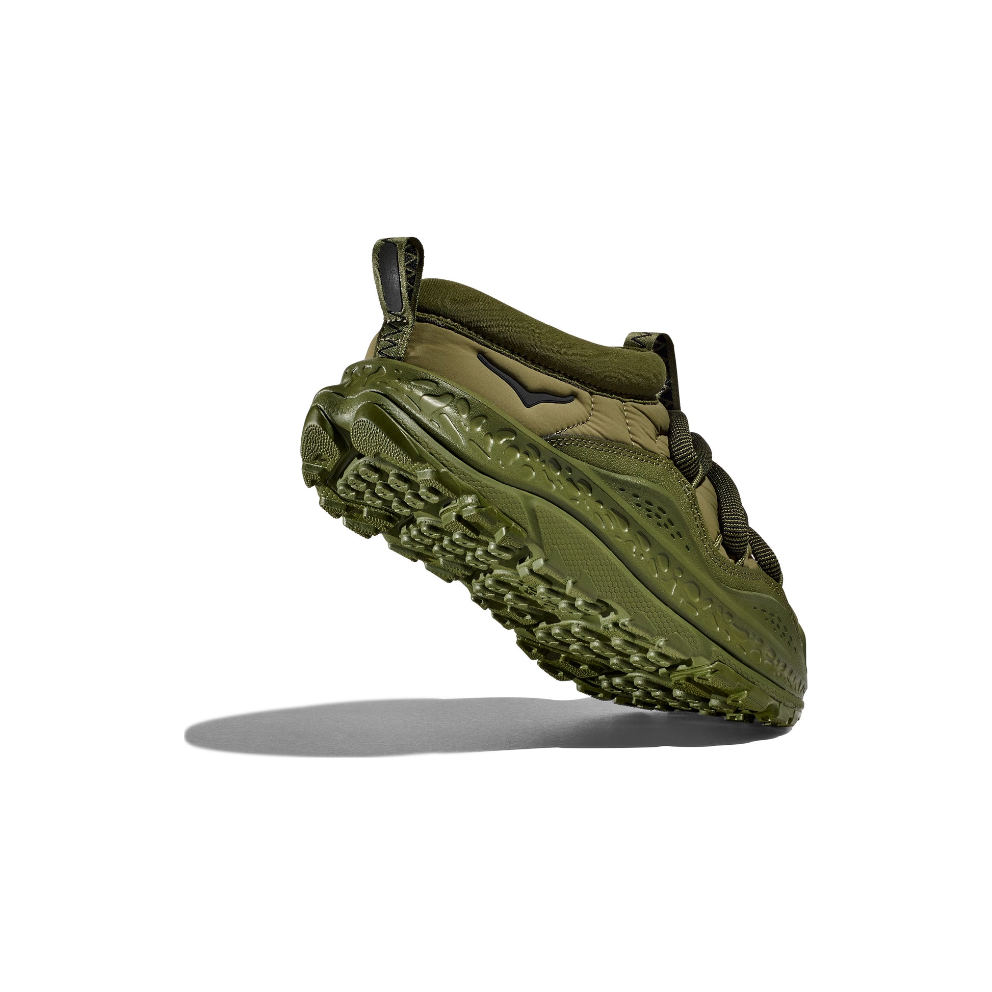 The Hoka U Ora Primo, Green, is a trail shoe with an olive hue and rugged sole, crafted for lifestyle comfort. It is featured side-on against a white backdrop with a subtle shadow.