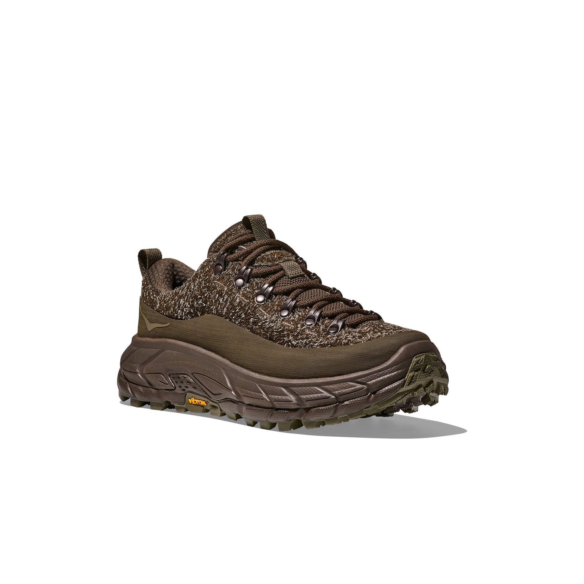 The U Tor Summit TP, a Hoka hiking shoe, features brown textured fabric with a sturdy sole and yellow side logo. Combining functionality and comfort, it's perfect for trails and rugged workwear, ensuring every step is supported by HOKA cushioning.