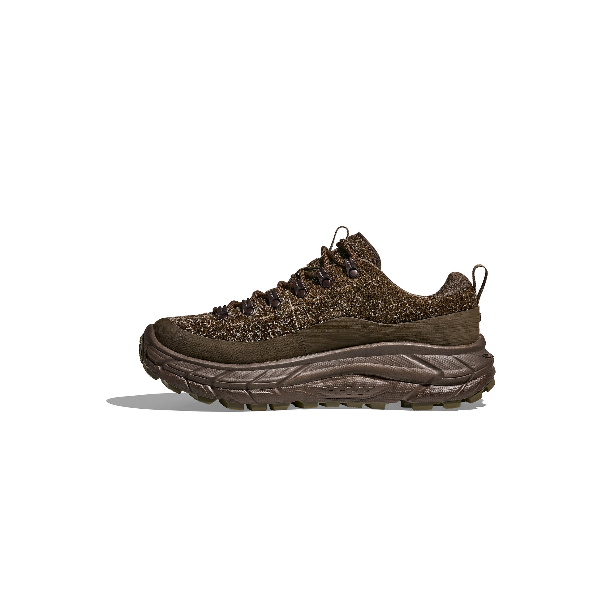 Side view of the Hoka U Tor Summit TP hiking boot, showcasing a brown color, thick sole, lace-up design, and textured details on a white background. Designed for rugged terrain with HOKA cushioning to enhance comfort on every adventure.