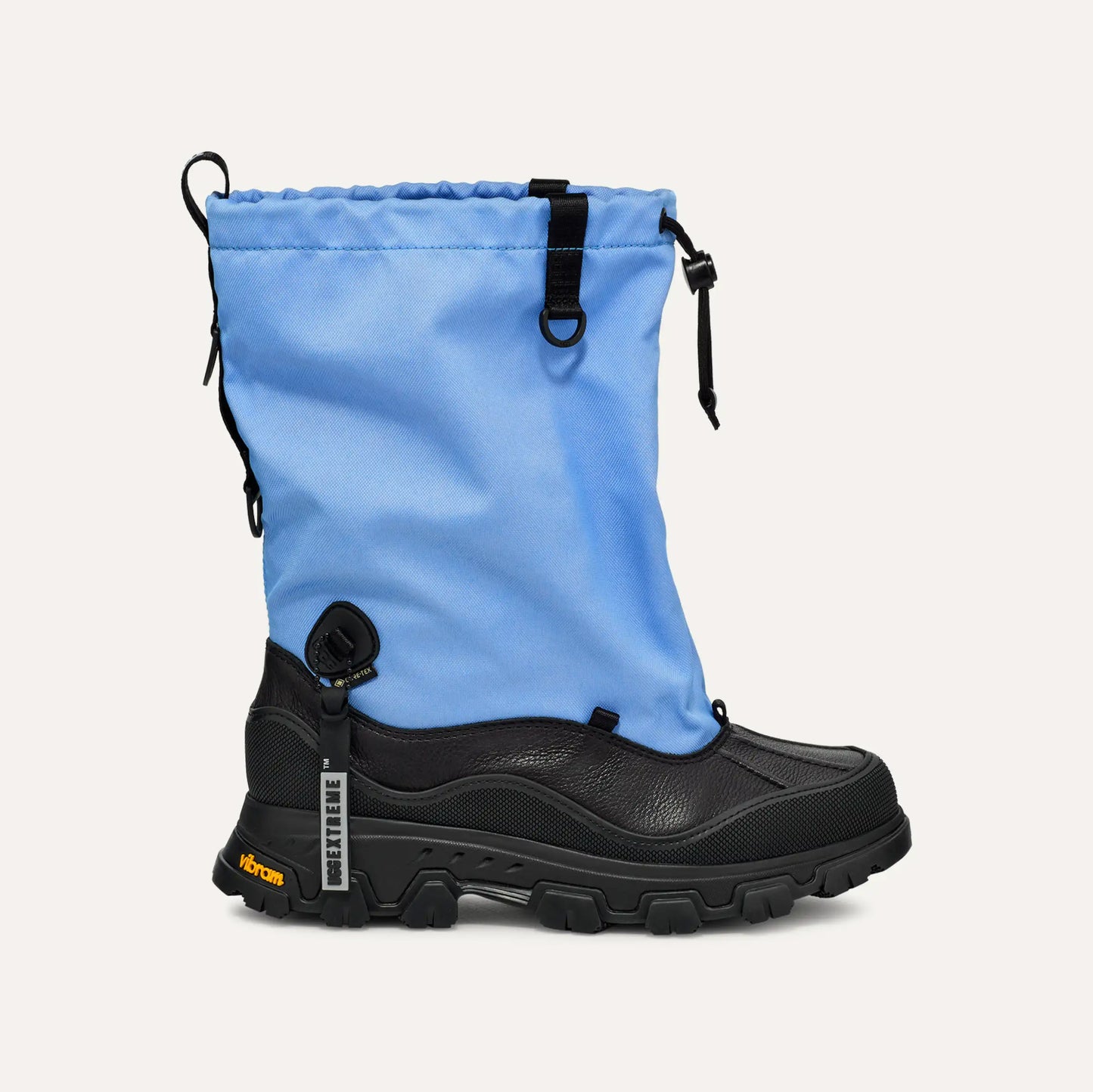 Ugg's W Metropeak boot features a blue upper gaiter and black lower section, making it ideal for winter. Its chunky Vibram sole is waterproof and includes adjustable toggles, combining style with functionality for brisk days.