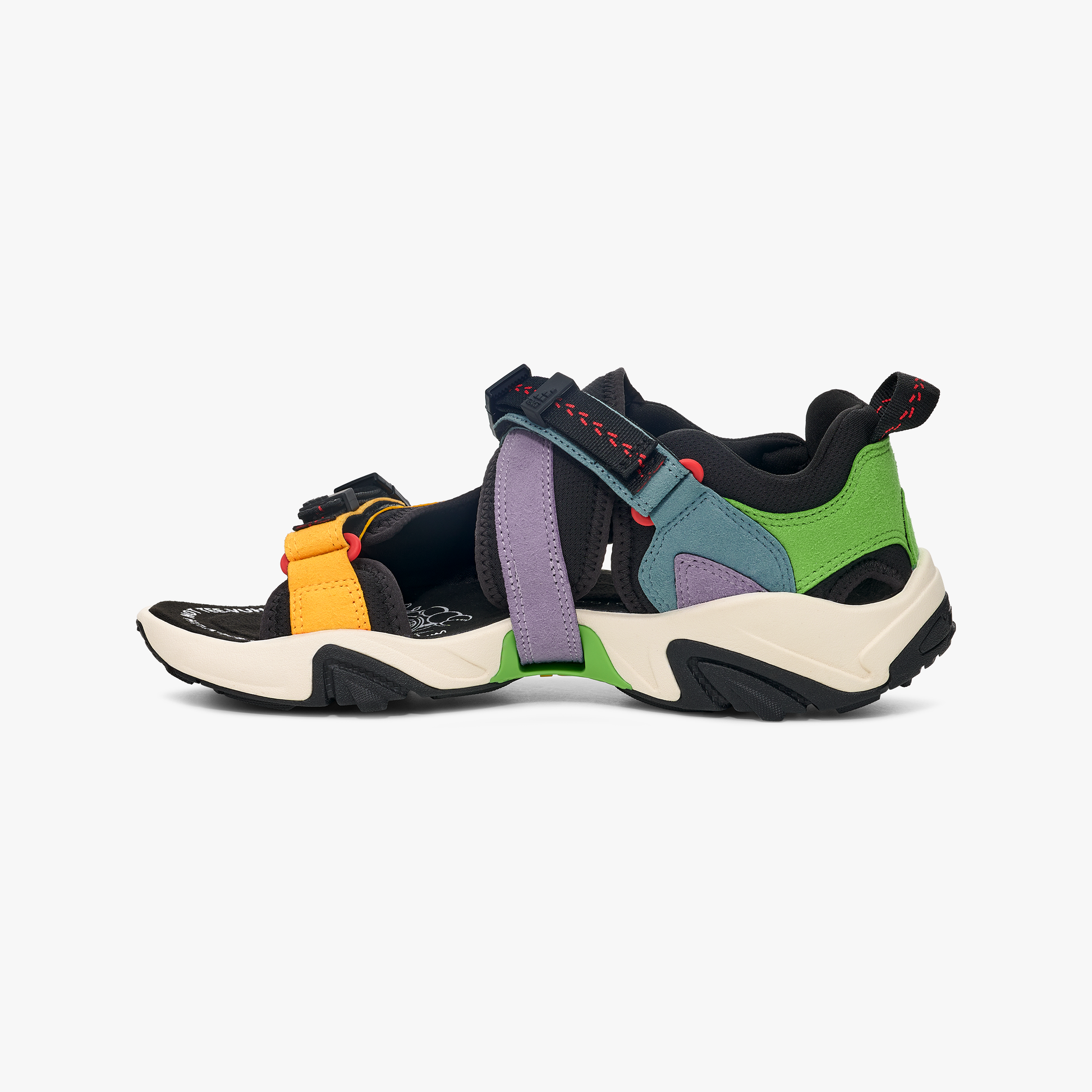 The Teva U SW X WRAPTOR Sandal features a black, green, orange, purple, and blue 360-degree strapping system with a thick cream and black sole, shown from the side on a white background.