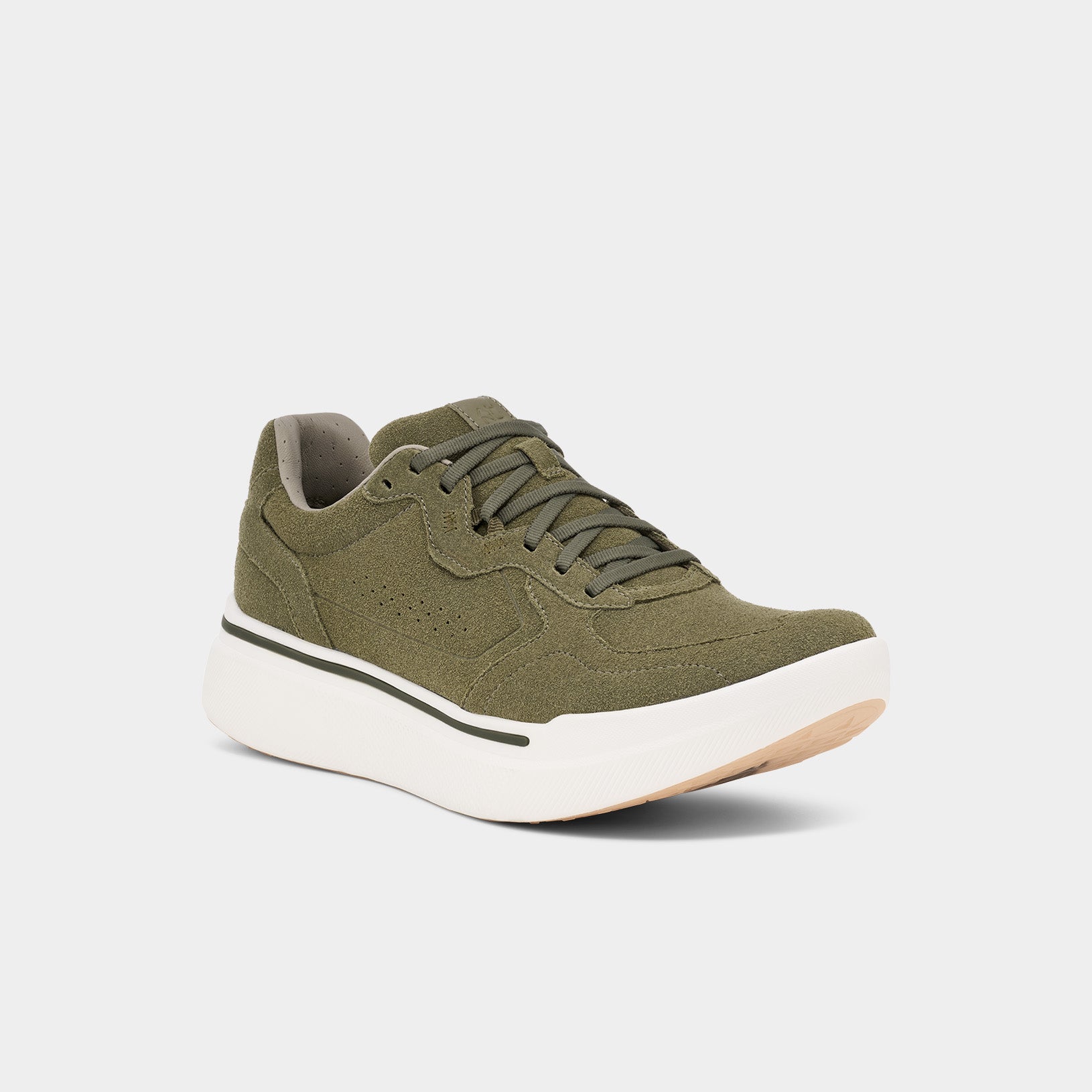 The M Sequence 1.1 Suede by AHNU features an olive green sneaker with a thick white sole, black stripe, and a rocker for enhanced movement. Made of textured fabric with matching laces and a tan underside, it offers style and functionality.