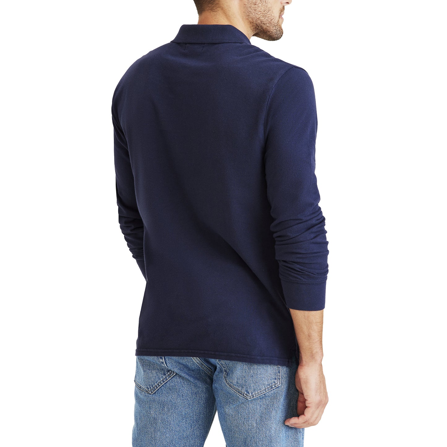 A man is shown from the back, standing against a white background, wearing Dockers Men's Pique Polo, LS in slim fit with a no roll collar and long sleeves, paired with blue jeans.