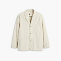The D-Series Chore Coat by Dockers, from the Transnomadica Collection, is cream-colored and features three buttons, a notched lapel, and three front pockets on a plain white background.