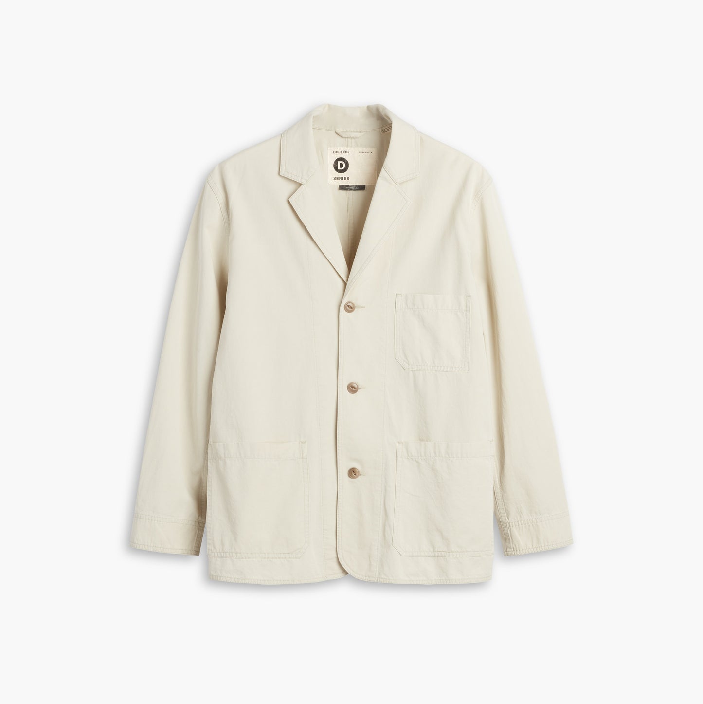 The D-Series Chore Coat by Dockers, from the Transnomadica Collection, is cream-colored and features three buttons, a notched lapel, and three front pockets on a plain white background.