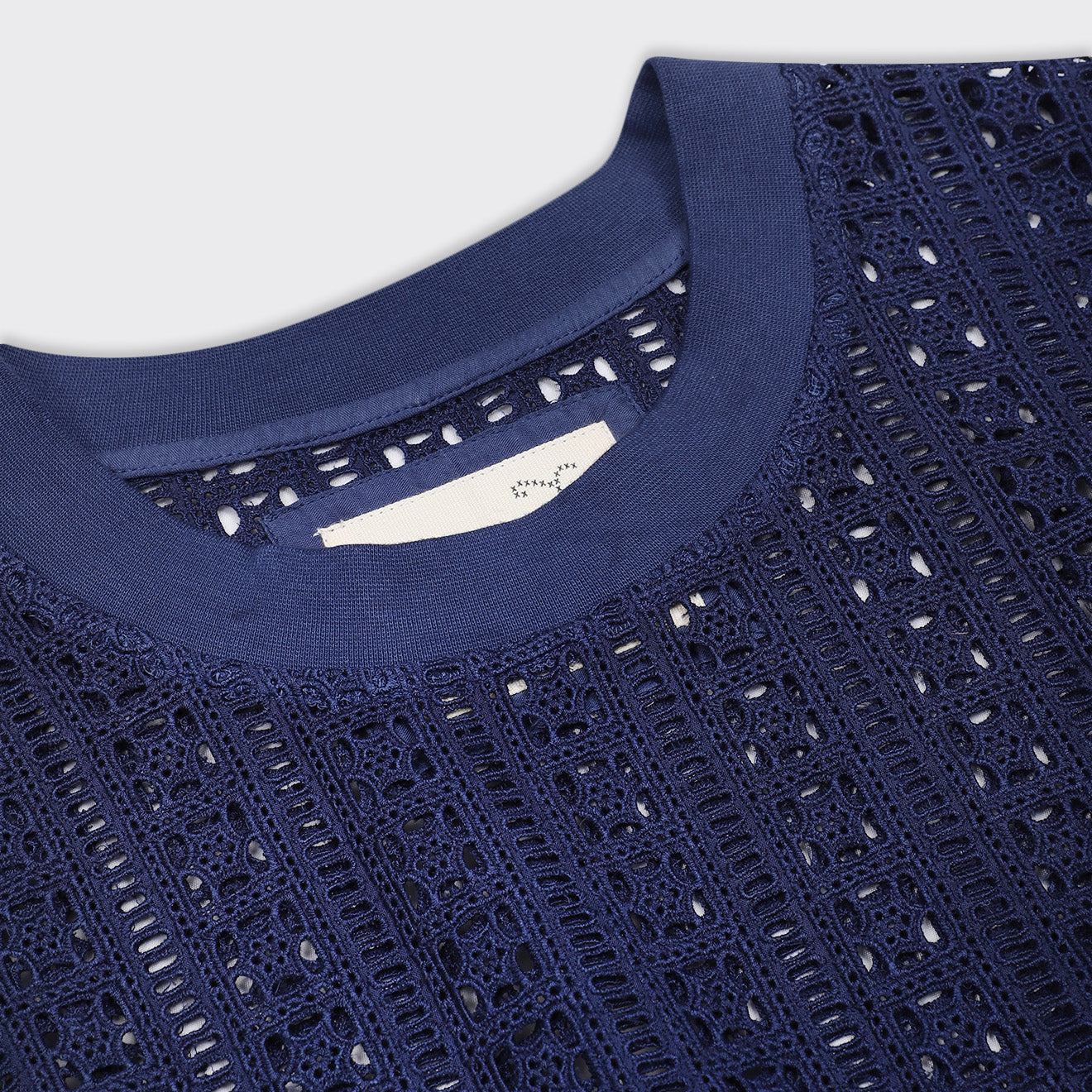 Close-up of the Kardo Noto Vest in Future Dusk, featuring a round neckline and intricate geometric lace pattern.