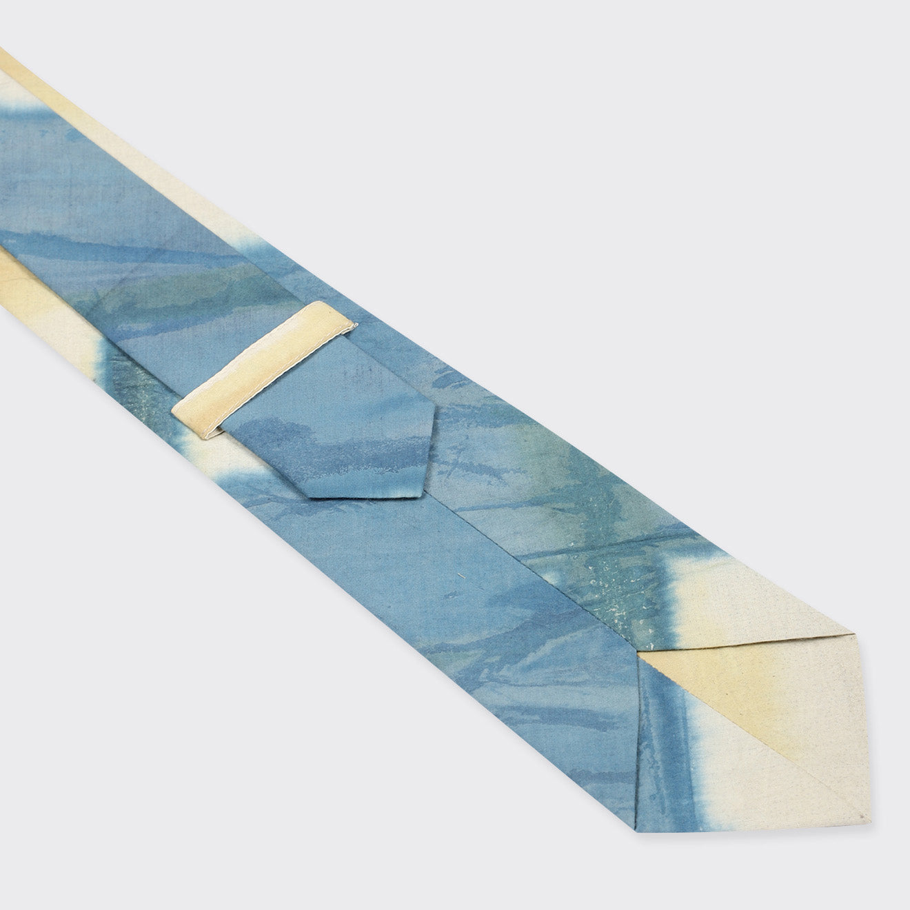 A Tie, Yellow Clamp Dye by Kardo is shown from the back, highlighting the loop and pointed tip.