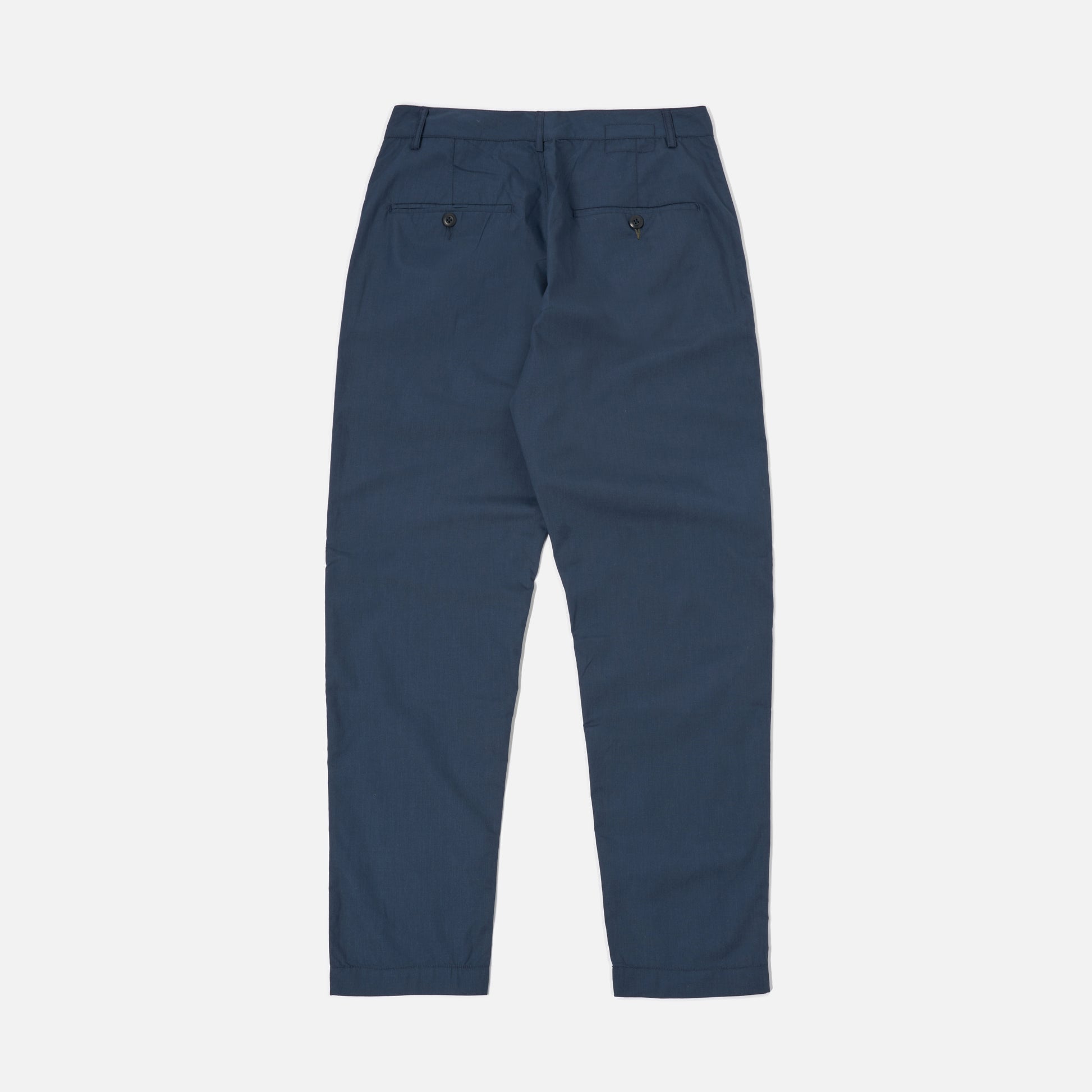 Universal Works Recycled Poly Tech Military Chino in navy, shown flat from the back, features two buttoned rear pockets and belt loops.