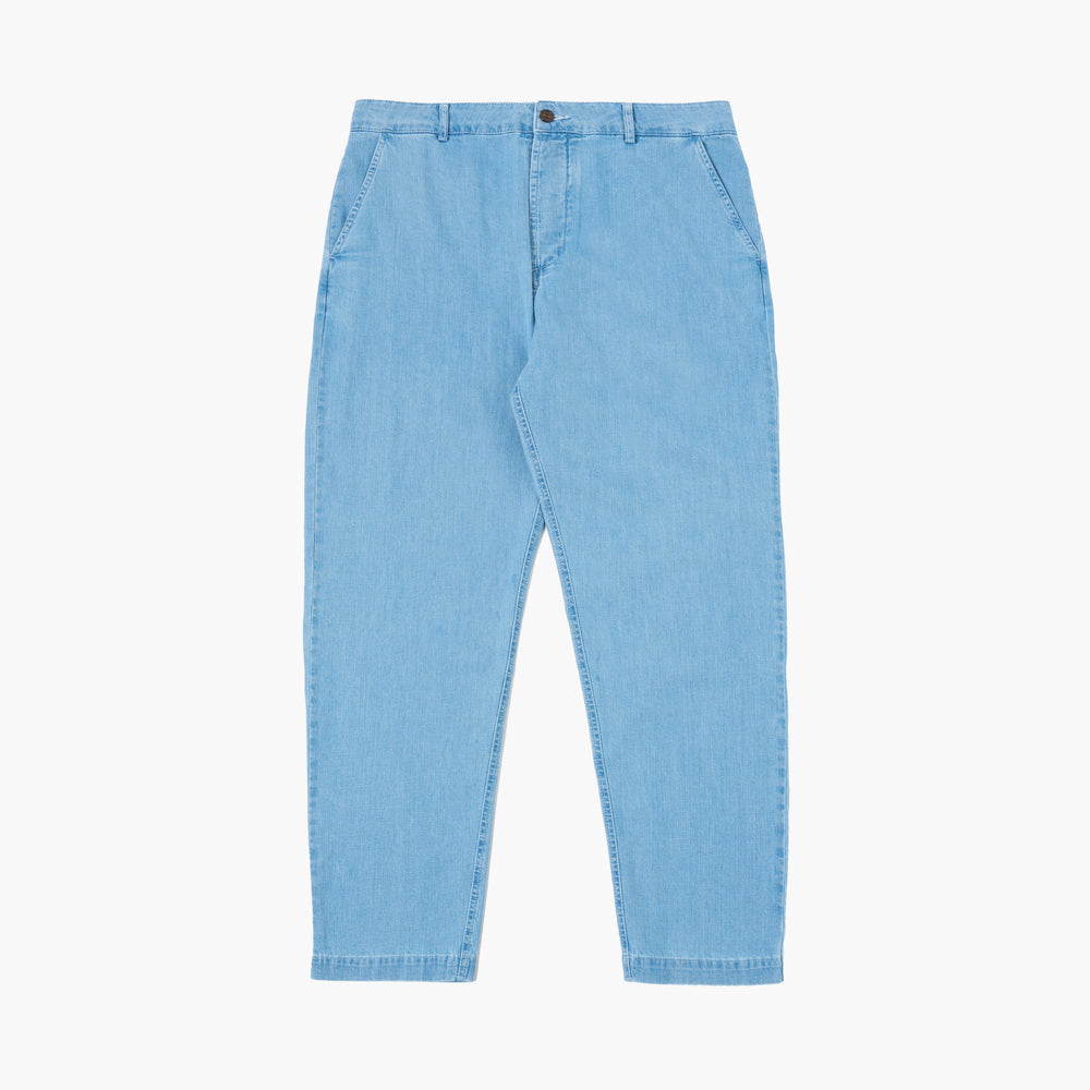 Washed indigo 8 Oz Organic Denim Military Chino by Universal Works, featuring a button and zipper closure, front pockets, and straight legs; displayed on a white background.