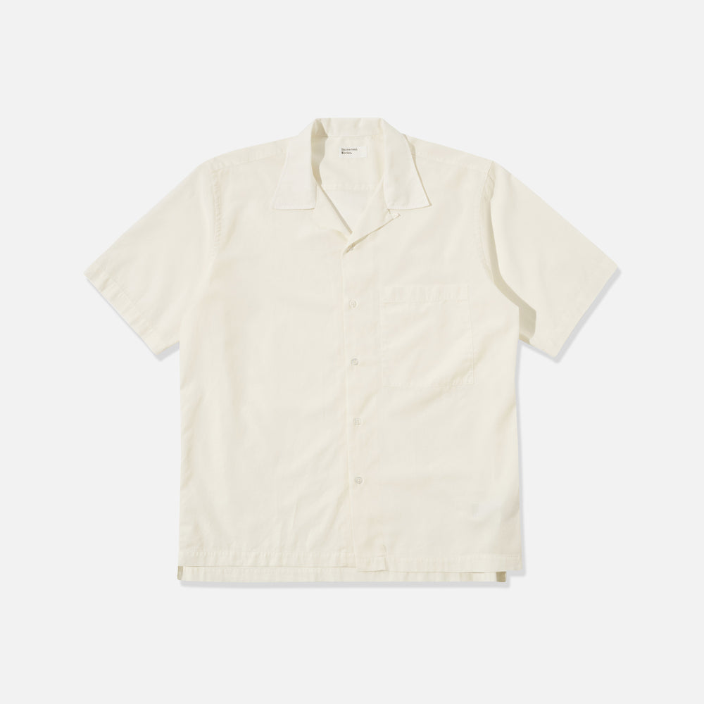 The Universal Works Gardenia Lycot Camp Shirt in ecru is a short-sleeved, button-up shirt with a chest pocket, shown laid flat on a plain white background.