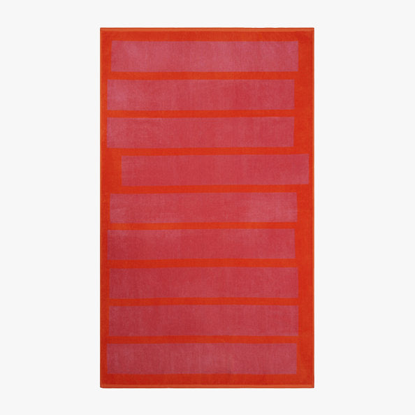 Stack Towel by Lateral Objects features a rectangular shape with a red border and horizontal pink stripes on a light gray background, evoking the plush softness of velour.