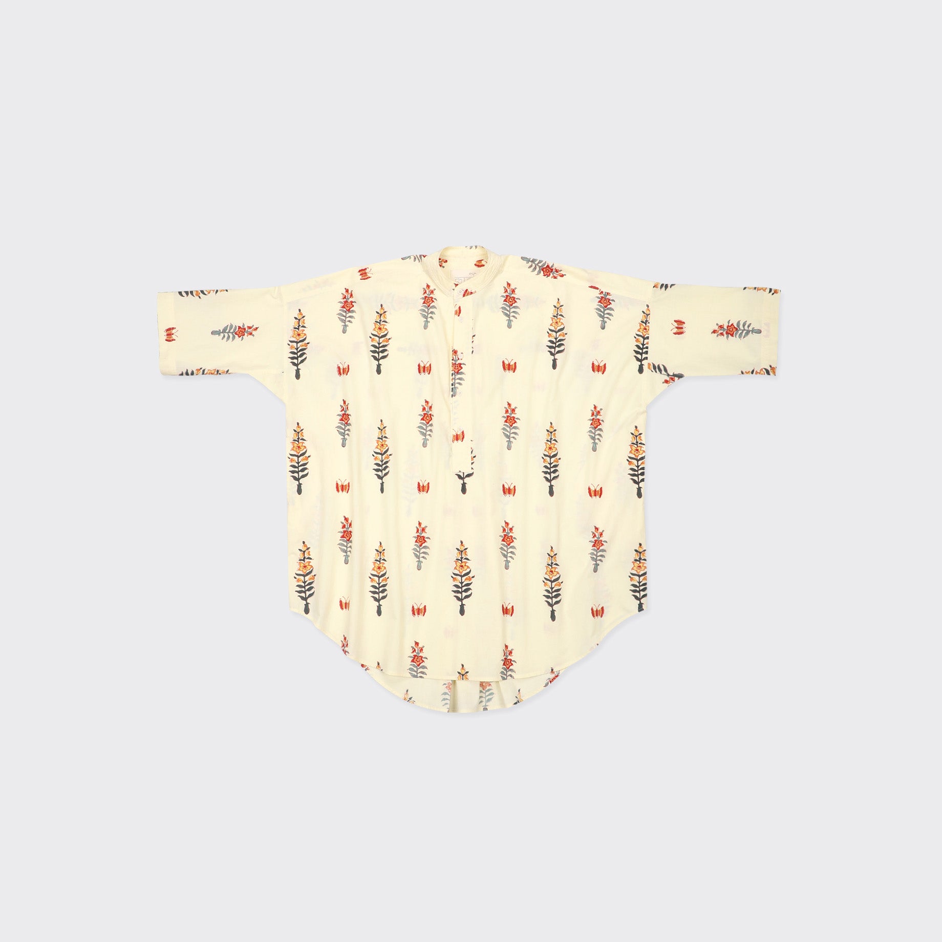The Kardo Aneek Shirt Dress, Block Print 138, is a cream long-sleeve shirt dress featuring red and gray floral prints, shown flat on a light background.