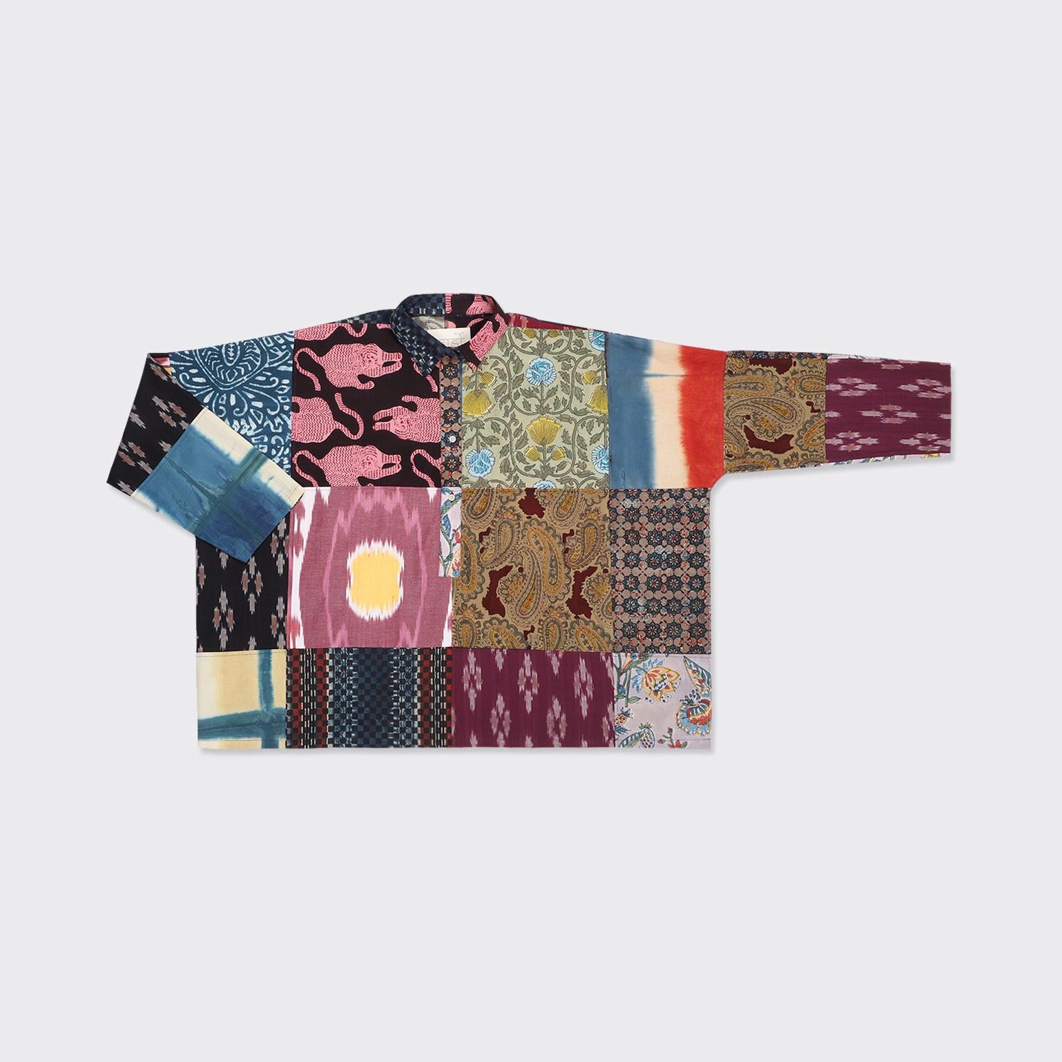The Kardo Fanette Overshirt, Patchwork 07, from the SS25 collection, features selected patchwork fabrics with colorful patterns and textures, displayed flat on a plain background.