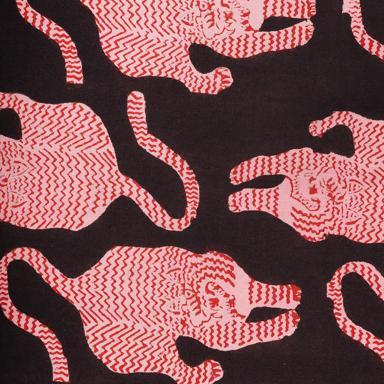 Kardo’s Tie, Coral Block Print features a repeating pattern of pink and red tiger-like figures with wavy stripes on a dark background.