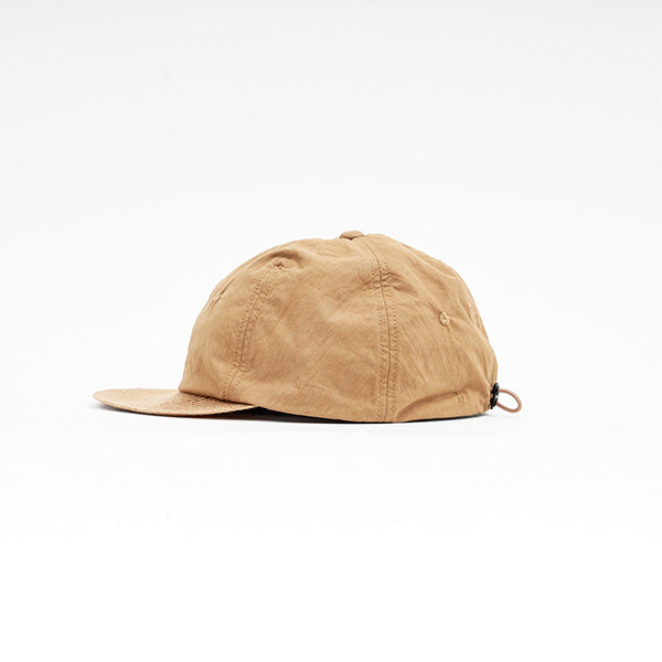 The Sublime Roe Charidoor Cap is a tan baseball cap featuring a curved brim and adjustable strap, shown against a plain white background.