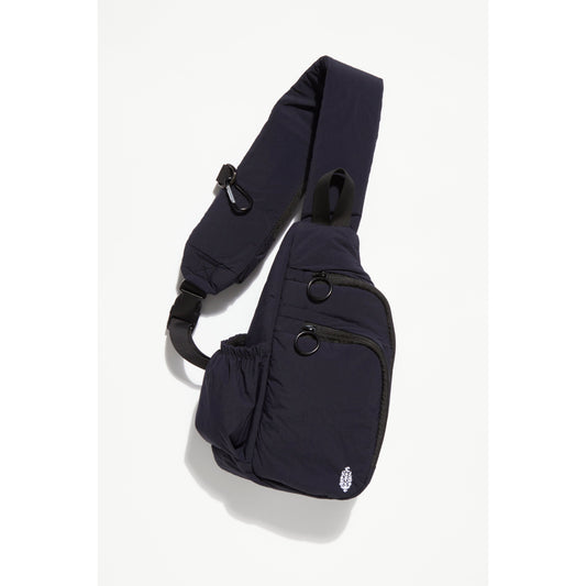 Renegade Sling, Black ergonomic baby carrier with adjustable crossbody straps and multiple pockets, isolated on a white background by Free People Movement.