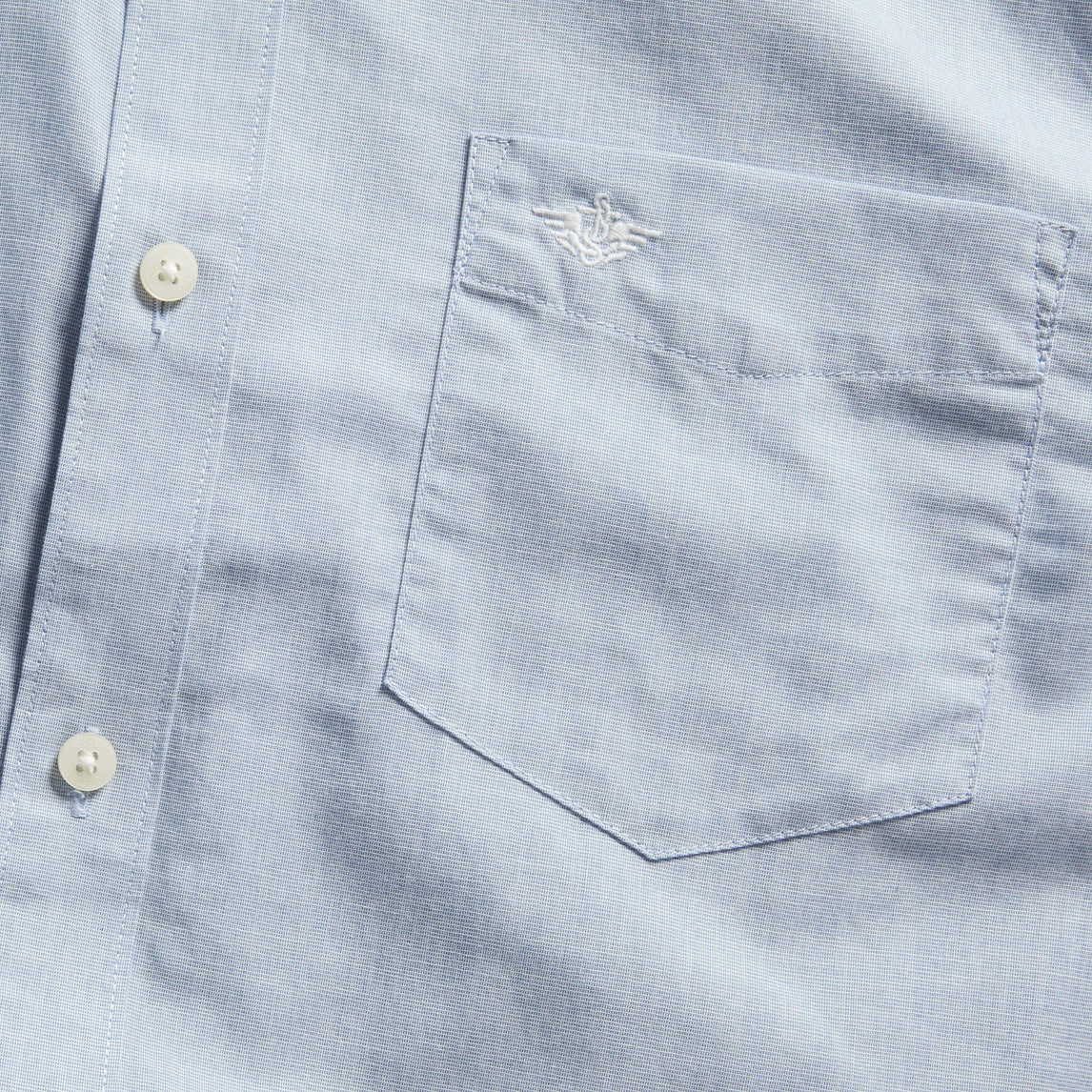 Close-up of the Dockers Men's Signature Shirt, LS in light blue, made from Mechanical Stretch Poplin with a chest pocket and a small embroidered logo above it.