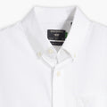 Close-up of a Men's Signature Shirt with Stain Defender by Dockers, featuring a white button-down design, Comfort Flex Collar, and a visible black Dockers label inside the collar.
