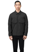 A person wearing the Nobis Ander Men's Mid Layer Shirt, which features PrimaLoft Gold Insulation and two chest pockets, stands against a white background.