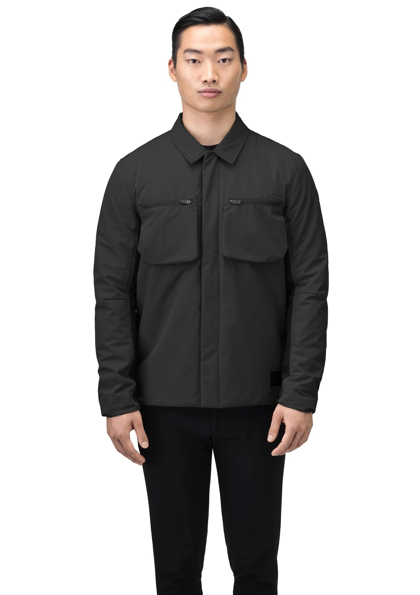 A person wearing the Nobis Ander Men's Mid Layer Shirt, which features PrimaLoft Gold Insulation and two chest pockets, stands against a white background.