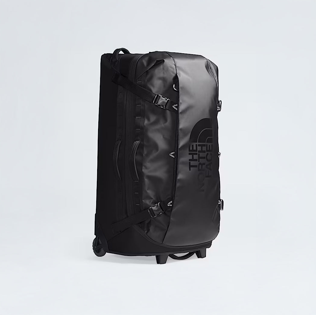 A large black The North Face Base Camp Rolling Thunder 36 Luggage with two wheels stands upright on a white background.
