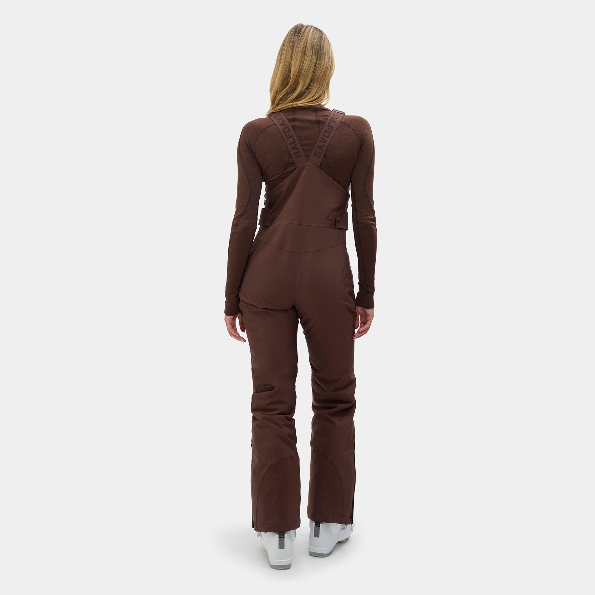 Person wearing a brown ski suit on a white background