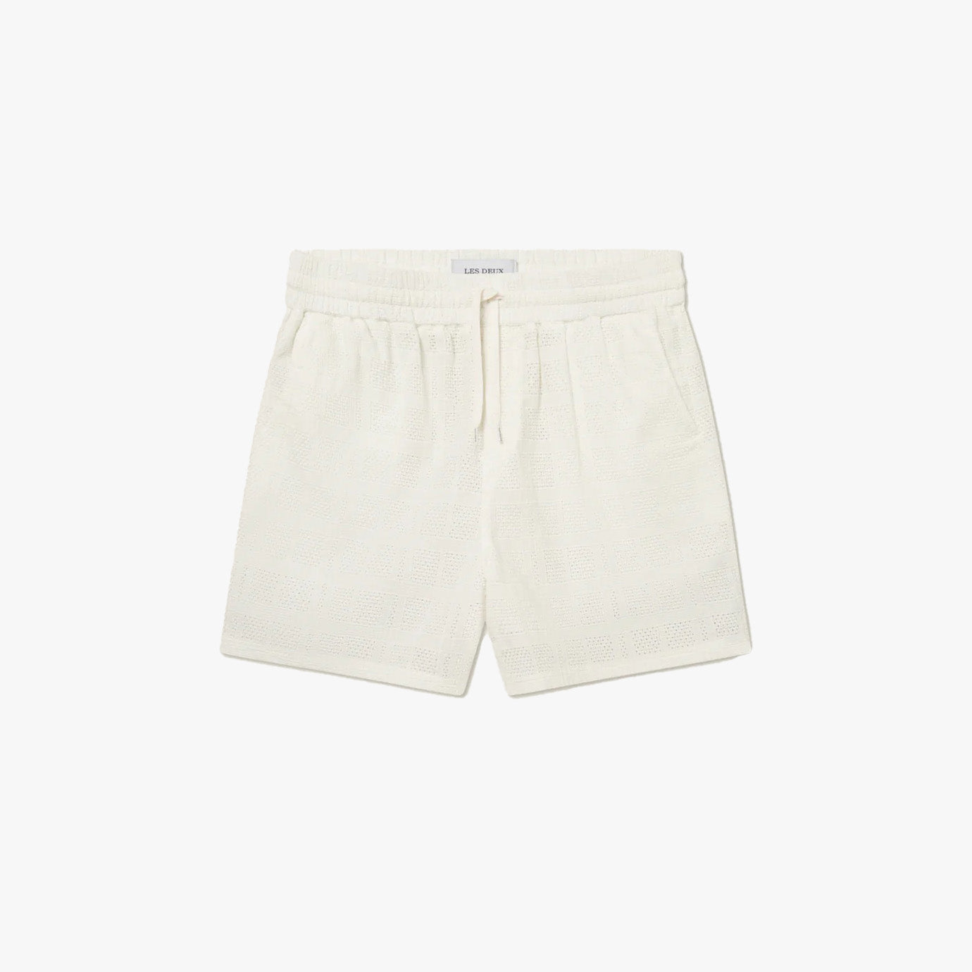 The Les Deux Charlie Shorts are white cotton shorts with an elastic waistband and drawstring, shown flat on a plain white background.