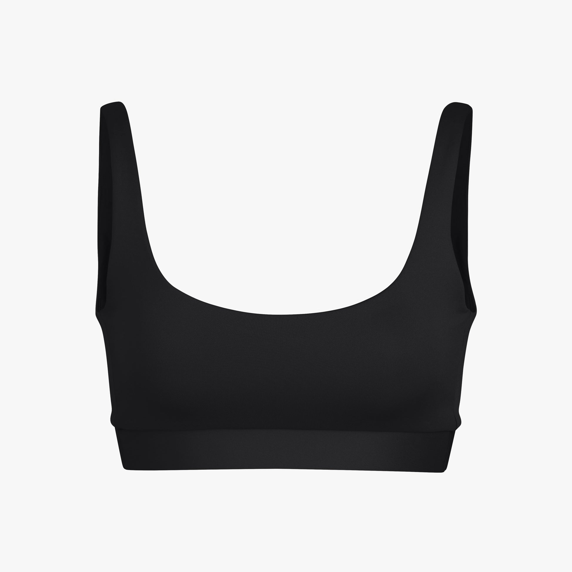 The Double Scoop Top by Left On Friday is a plain black sports bra with super soft straps, a scoop neckline, and a no-dig band for all-day comfort, shown against a white background.