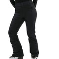 Individual wearing the Emma Pant by Halfdays in a slim-fit black style along with ski boots against a white background.