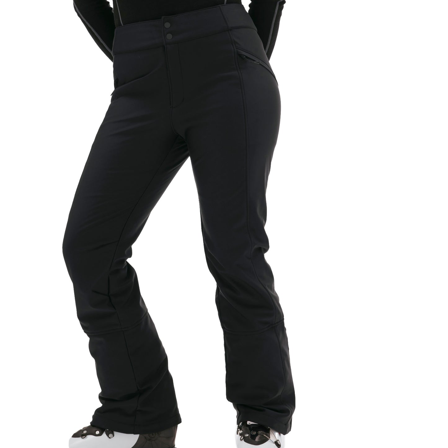Individual wearing the Emma Pant by Halfdays in a slim-fit black style along with ski boots against a white background.