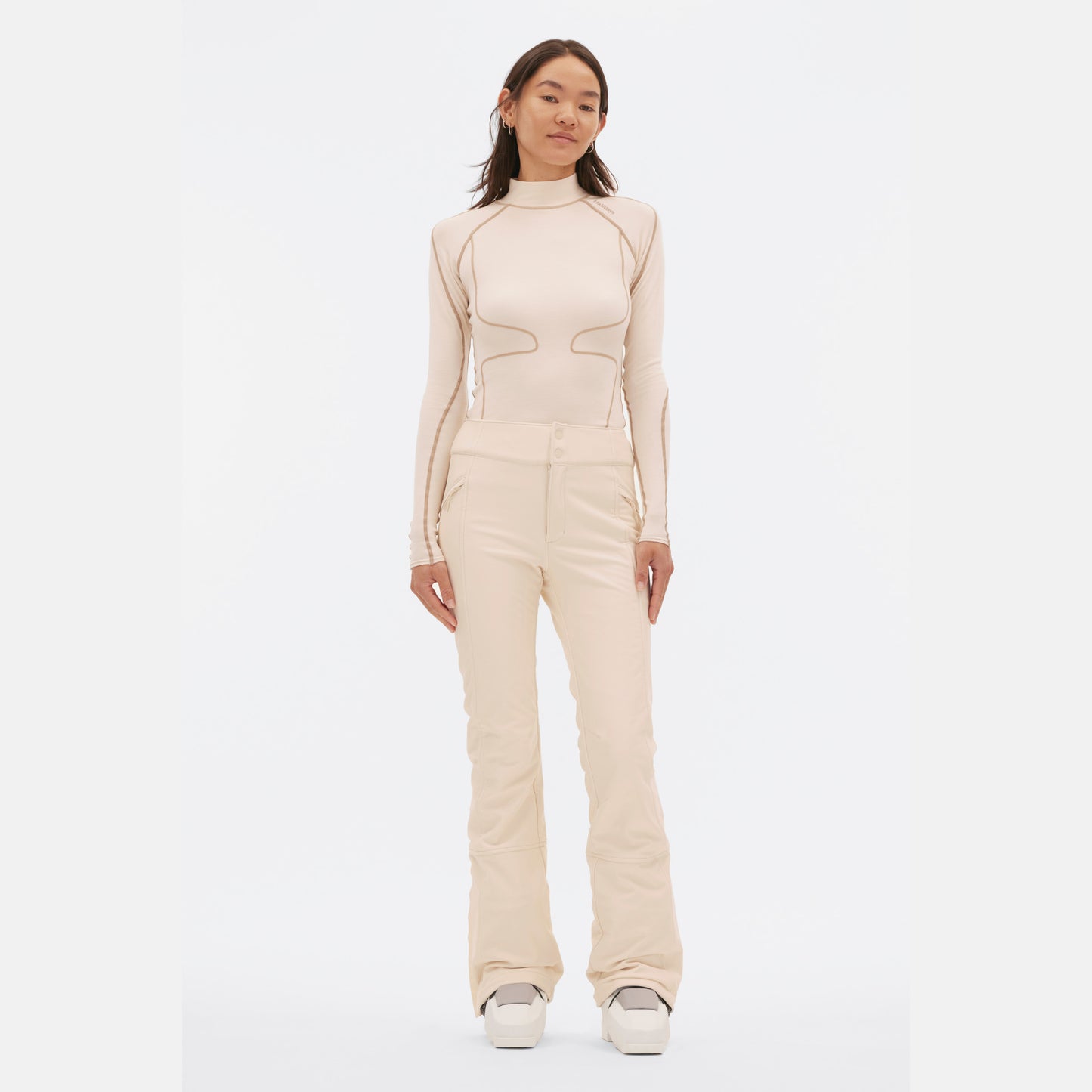 A person in a cream-colored slim-fit long-sleeve top and matching Halfdays Emma Pant poses against a plain white background.