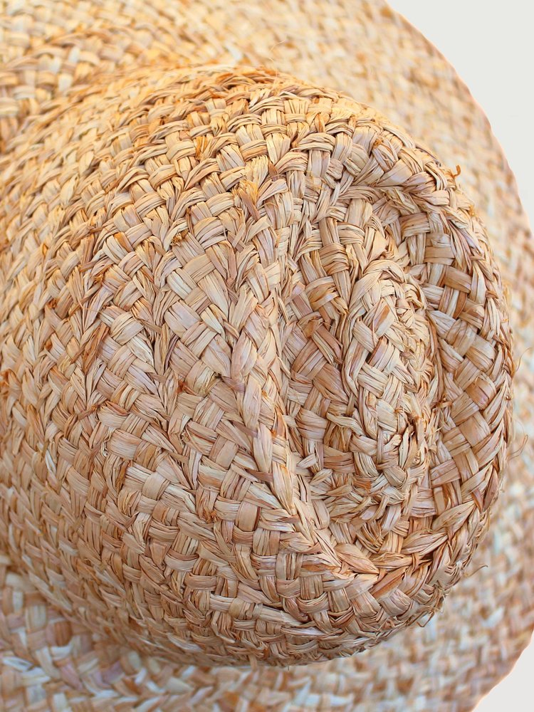 Close-up of a Lola Hats Fiscolo, Natural showcasing the detailed woven texture, focusing on the spiral pattern at the crown.