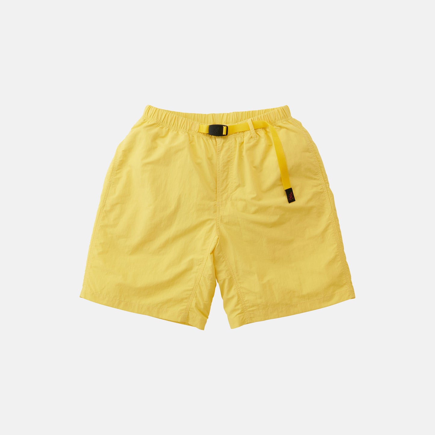 The Gramicci Nylon Loose Short is a yellow, water-repellent nylon pair of shorts featuring an elastic waistband and integrated adjustable belt, shown against a plain white background.