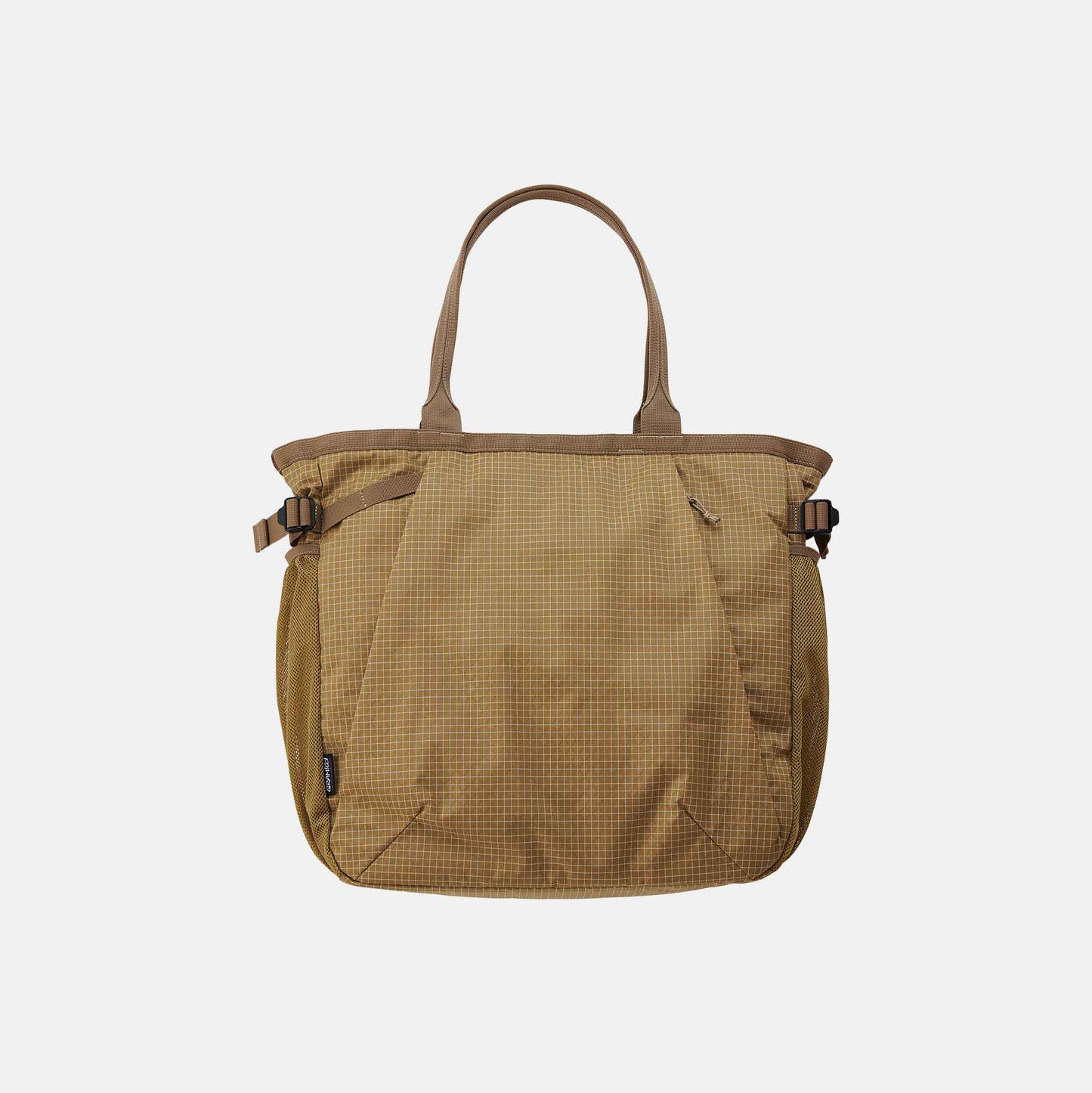 The Gramicci Riptstop Tote Bag features a beige checkered pattern, dual handles, and side buckles, set against a plain white background.