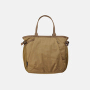 The Gramicci Riptstop Tote Bag features a beige checkered pattern, dual handles, and side buckles, set against a plain white background.