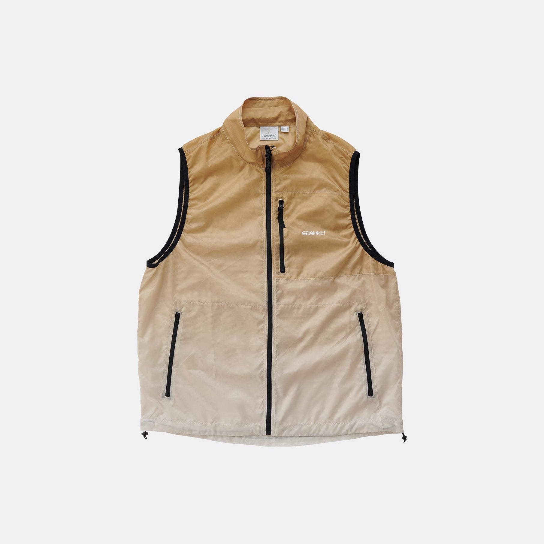The Gramicci Lt. Ripstop Windvest is a beige sleeveless vest with a black zippered front, pockets, high collar, and brand logo on the chest.