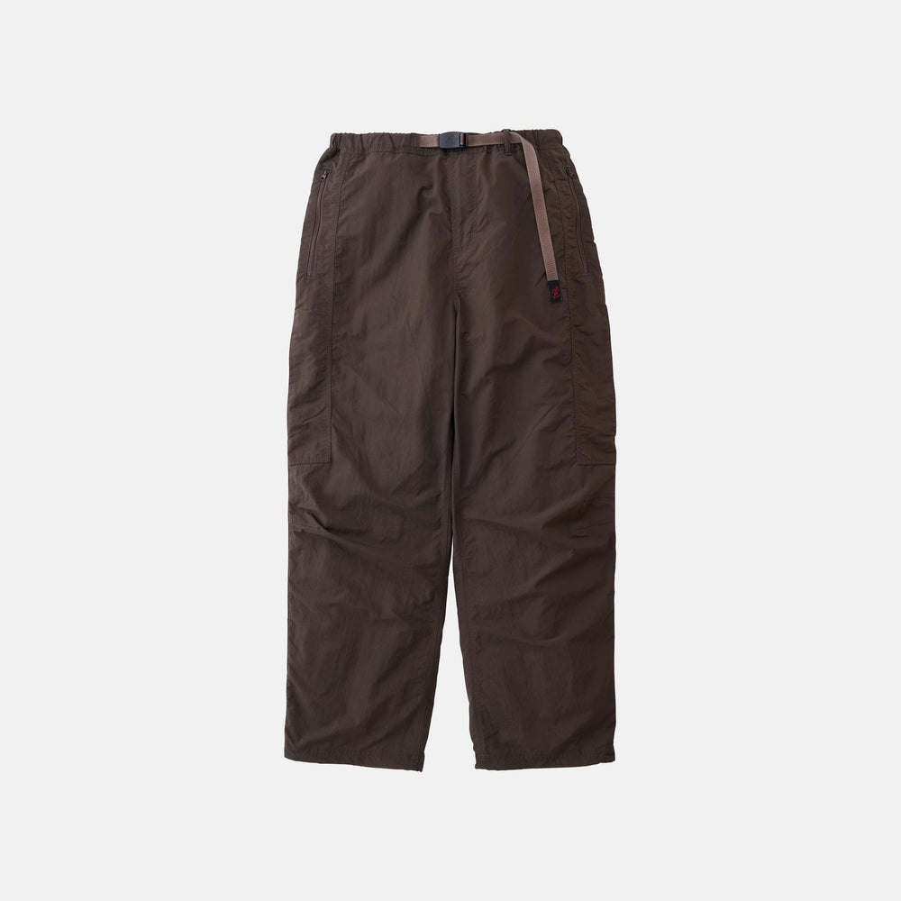 The Gramicci Nylon Runners are loose-fitting, dark brown pants with an adjustable waist belt, shown against a plain white background.