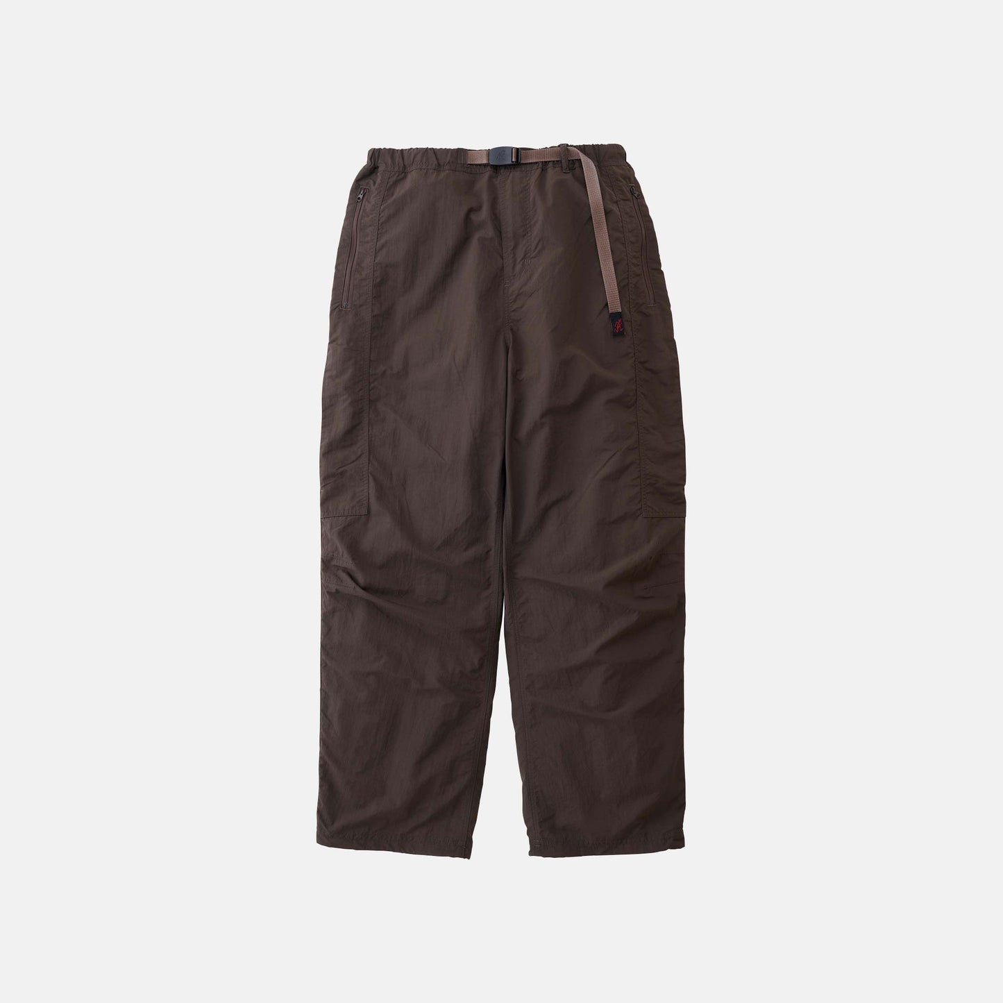 The Gramicci Nylon Runners are loose-fitting, dark brown pants with an adjustable waist belt, shown against a plain white background.