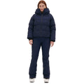 Wearing the Georgie Puffer Jacket by Halfdays, a person stands facing forward against a plain white background, highlighting its mountain performance features.