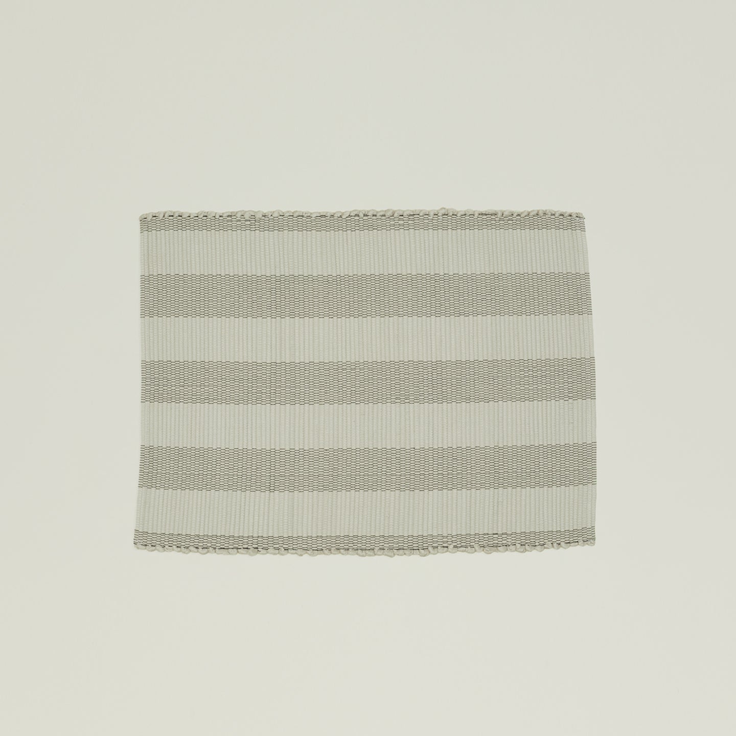 The Hawkins New York Essential Floor Mat, Light Grey, is made from 100% recycled fibers and features alternating light gray and white horizontal stripes for a subtle pop of color. It's machine washable for easy care.
