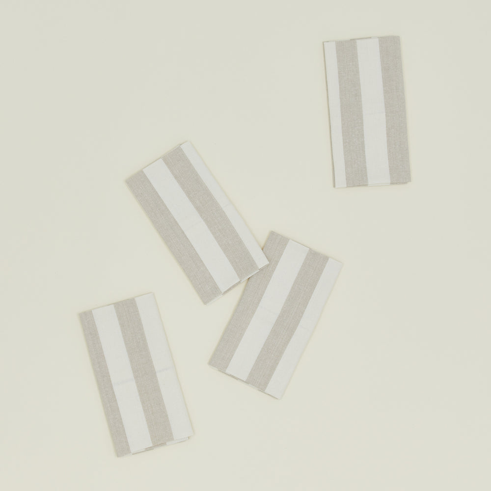 These Hawkins New York Essential Striped Placemats, set of four, are elegantly arranged on a light beige surface, embodying easy living.