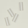 These Hawkins New York Essential Striped Placemats, set of four, are elegantly arranged on a light beige surface, embodying easy living.