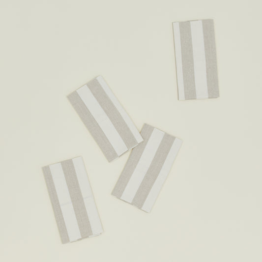 These Hawkins New York Essential Striped Placemats, set of four, are elegantly arranged on a light beige surface, embodying easy living.