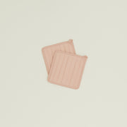 Set of 2 Simple Linen Pot Holders in blush by Hawkins New York, featuring square quilted design with heat-resistant padding and hanging loops, displayed on a light background.