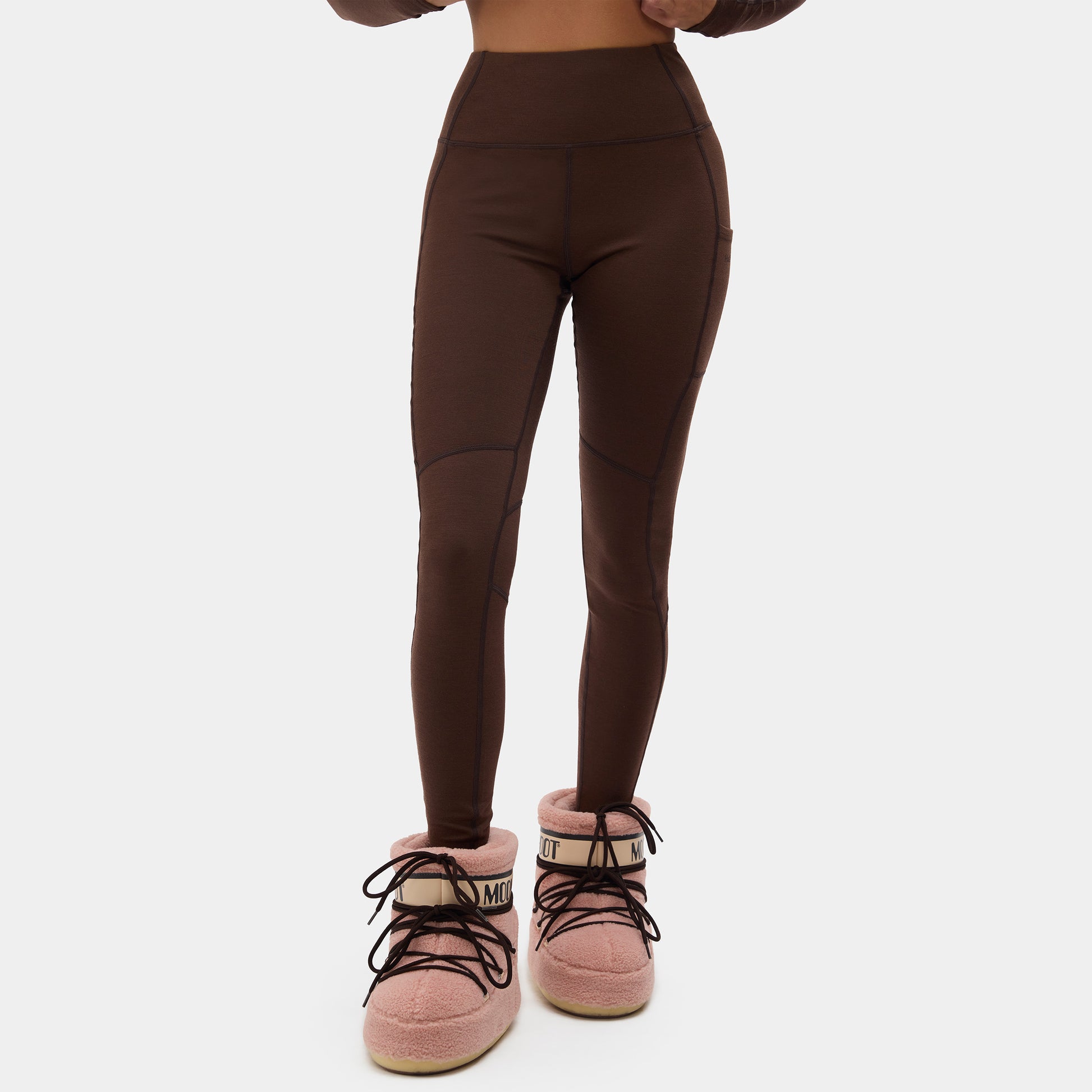 Brown leggings worn by a person on a white background